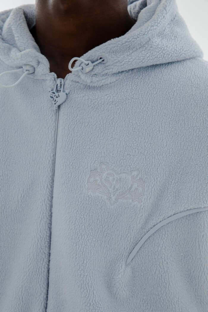 Embrace the perfect fusion of style and coziness with the Star Wreath Fleece Zip Zen Blue.