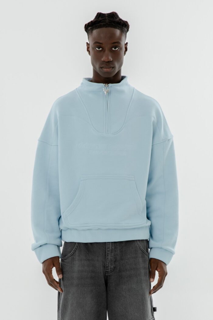 Elevate your style with the More Money Logo Halfzip in Baby Blue.
