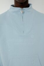 Elevate your style with the More Money Logo Halfzip in Baby Blue.